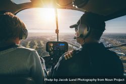 Man and woman flying in a helicopter bxLEnb