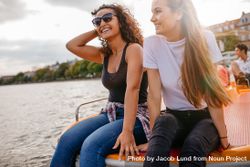 Outdoors shot of two female friends sitting in front pedal boat 4dPYL4