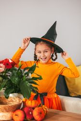 Little Girl Playing With a Pumpkin.