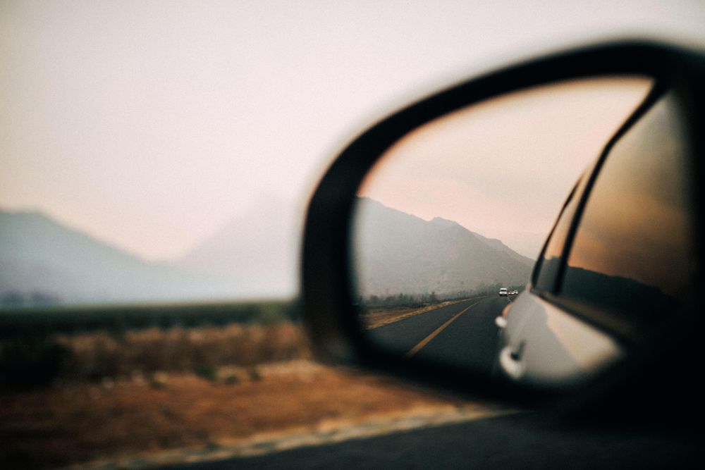 View of the mountains in the rearview mirror
