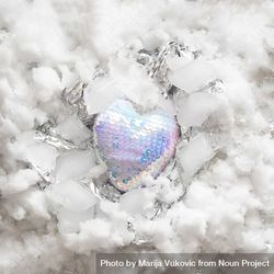 Heart in iridescent sequins on snowy and silver background 5pYLv4
