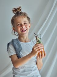 Happy boy with glass of lemonade