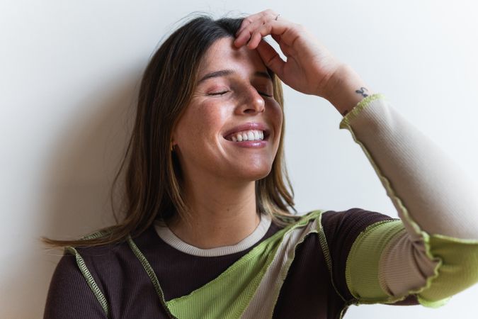 Gentle woman resting on chair smiling with eyes closed