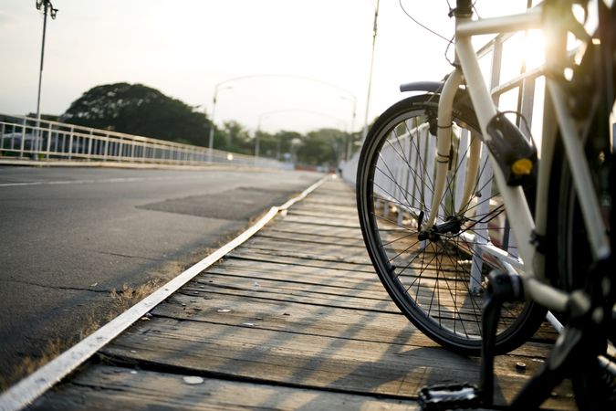 Bike wheel on bridge with sun flare