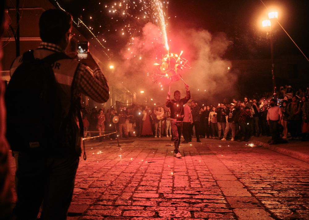 Man doing fireworks display during parade at night