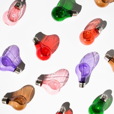 Colorful lightbulbs on light background