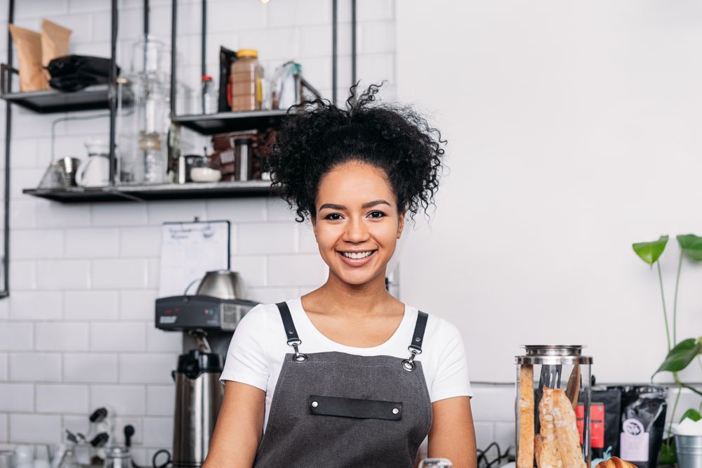 Portrait of happy barista in cafe