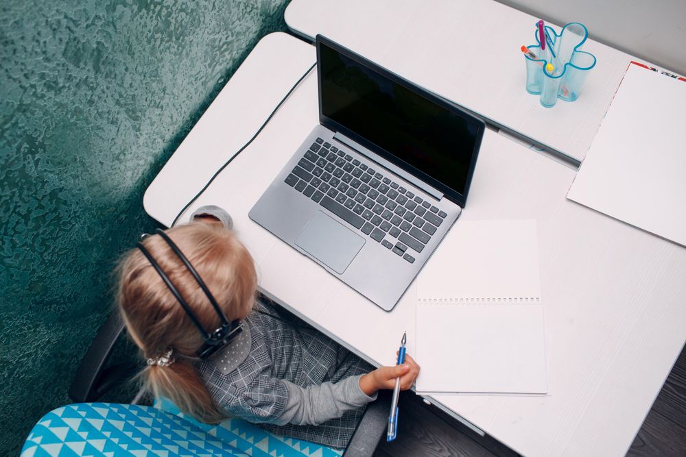 Top view of young girl using laptop