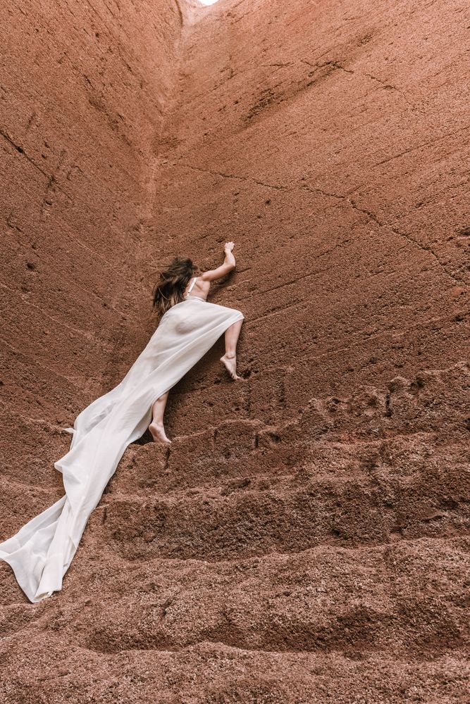 Elegant female posing on rocky cliff
