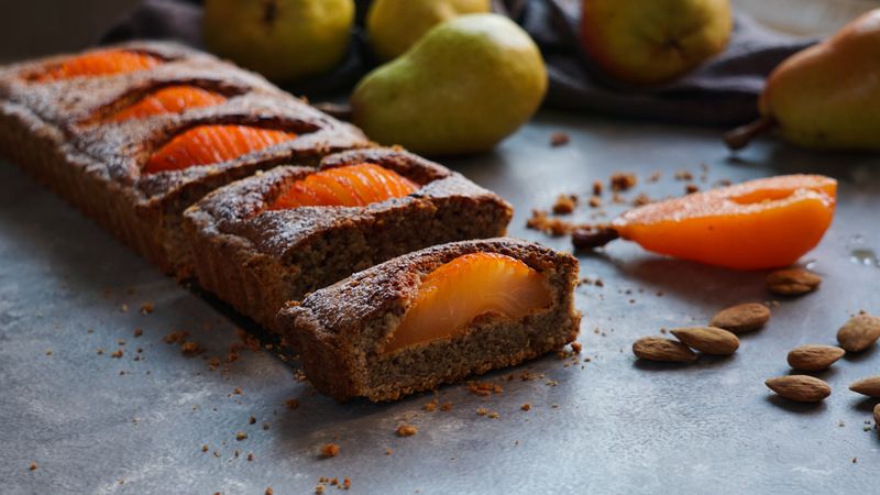 Pear cake and fruits on table