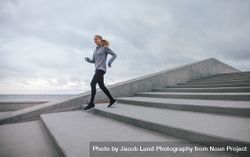 Healthy young woman running down on steps 5r9vl2