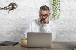 Serious man sitting in front of computer