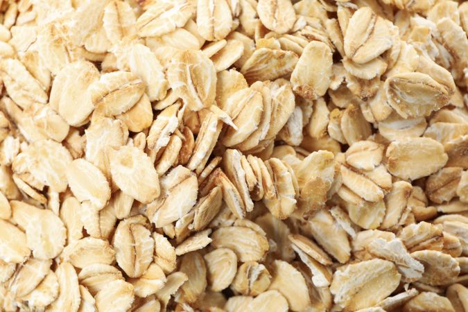 Oatmeal flakes texture on whole background, close up