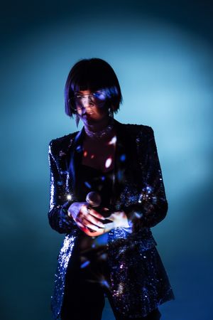 Stylish woman singing on stage