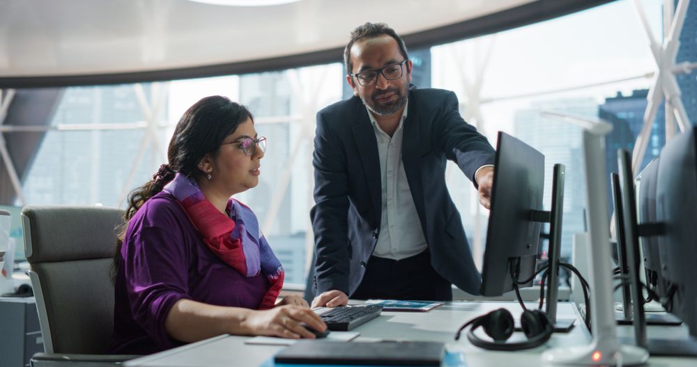 Financial Analyst Having a Meeting to Discuss a Business Project with an Indian Team Leader.