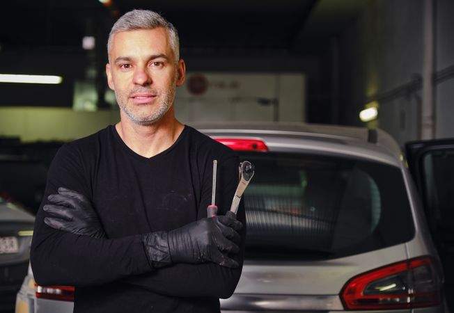 Confident mechanic in garage