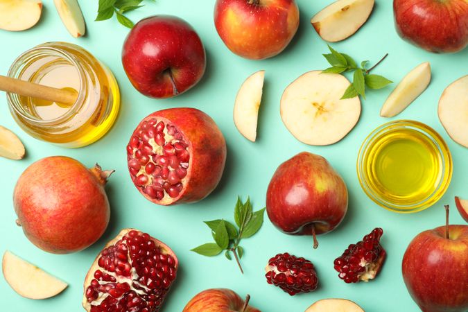 Flat lay top view of autumnal fruit scattered on mint background