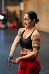 Woman stretching arms after working out in a gym