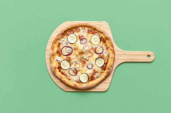 Vegetarian pizza on wooden board, top view