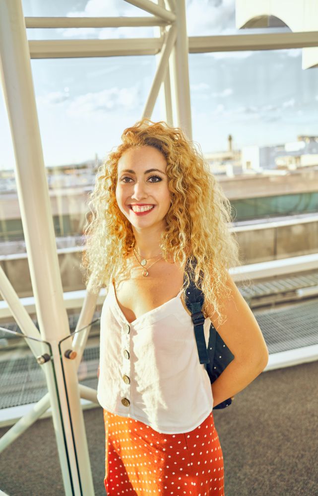 woman walking in spacious hall in sunlight