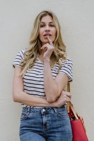 Blonde woman with finger on lips
