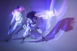 Anonymous dancers under violet illumination