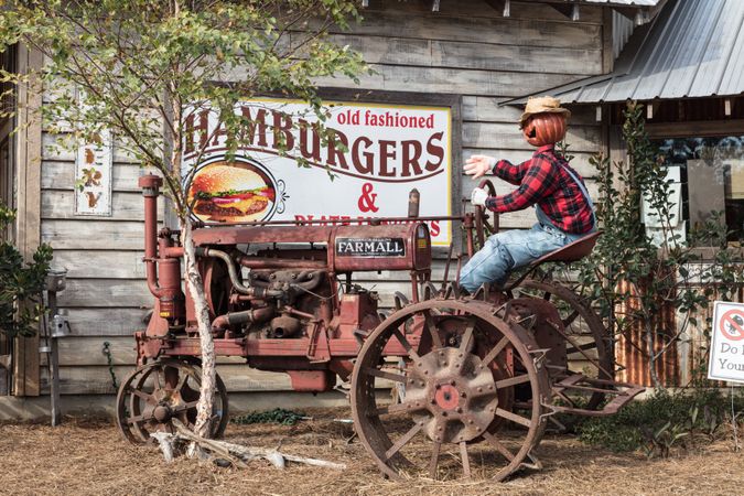 Pumpkin scarecrow on tractor, Shady Acres Village, Sanford, Mississippi