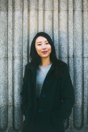 Asian woman near marble wall