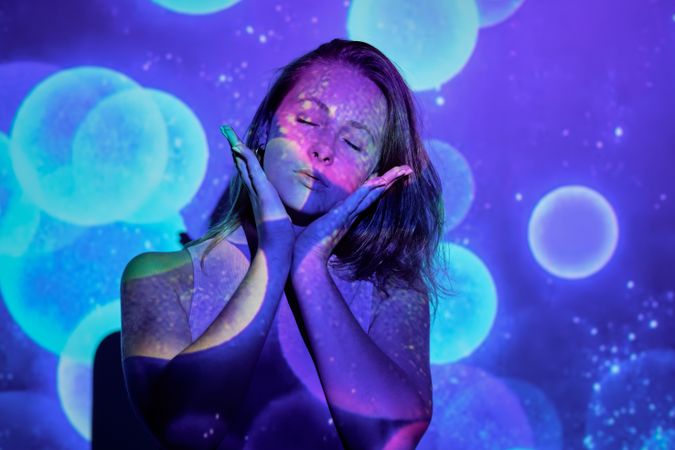 Trendy woman under colorful illumination
