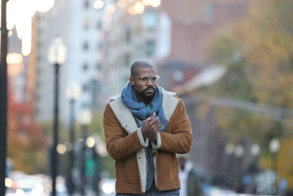 Man wearing jacket walking in street