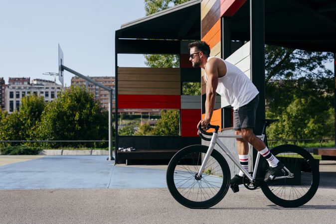 Man riding bike next to buildings