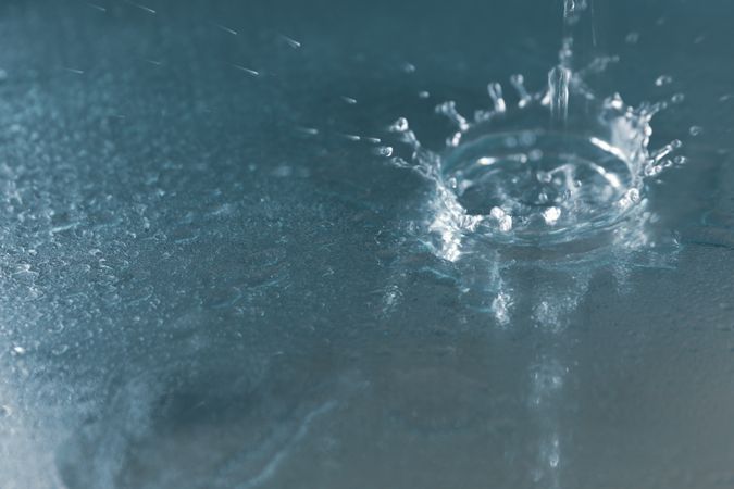 Drop of water on blue surface