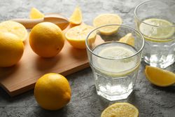 Composition with lemonade and lemons on gray background