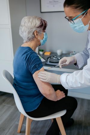 Mature woman being vaccinated against coronavirus