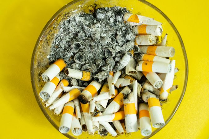 Top view of ash and cigarette butts in ash tray