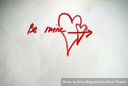 Valentine Day holiday card concept with "Be Mine" and heart scribbled on paper 0LddLP
