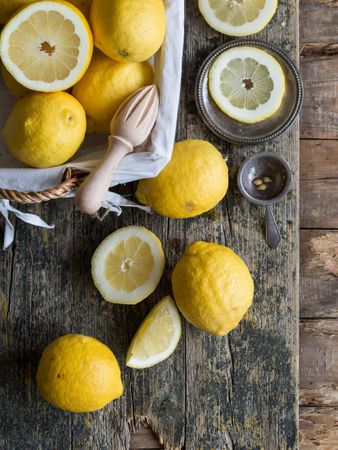 Lemons and reamer placed on wooden board