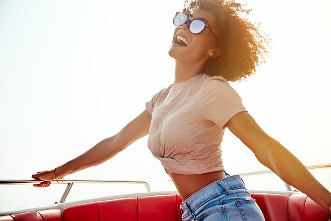 Happy woman smiling in boat with sunglasses