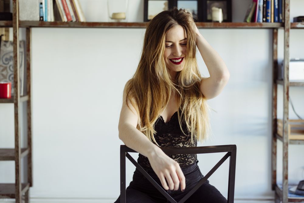 woman in bra sitting on chair