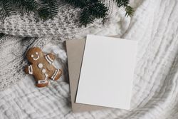 Christmas still life with card next to gingerbread cookie