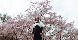 Girl standing near blooming tree