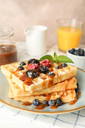 Composition of breakfast with belgian waffles, space for text