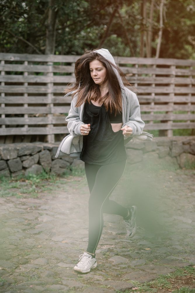 Positive woman running in park