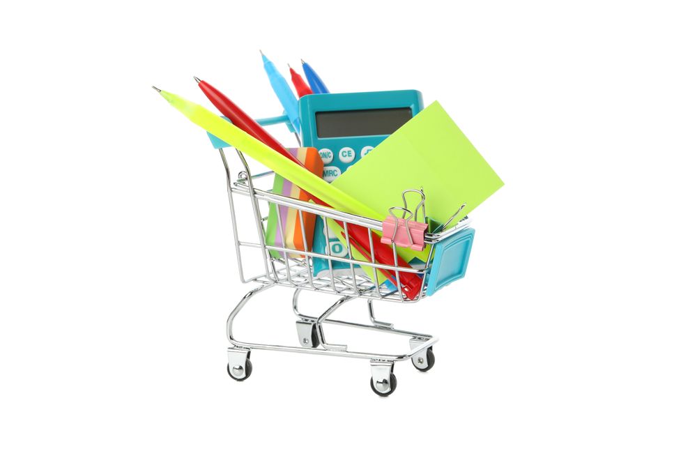 Shopping cart filled with pens and calculators