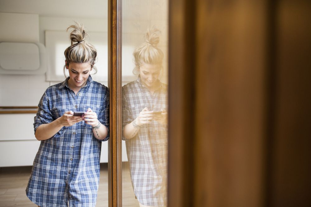 Woman at home on the mobile phone
