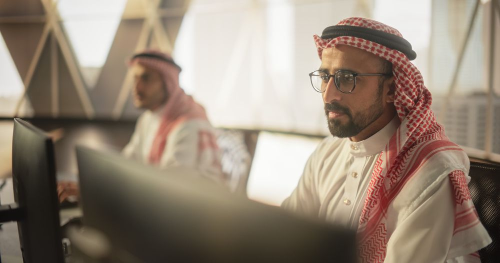 Portrait of a Middle Eastern Software Developer Working on Computer in a Technological Corporate Office.