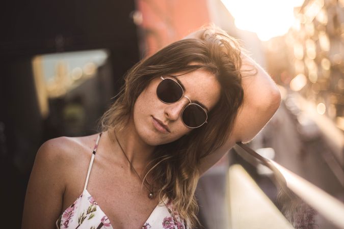 Woman against sunny blurred background