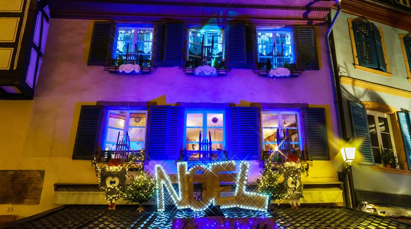 House with the word "Noel" lit up in front for Christmas