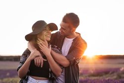 Couple in love in a lavender field at sunset