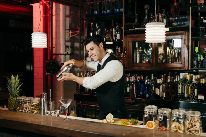 Barman working mixing drinks in a shaker